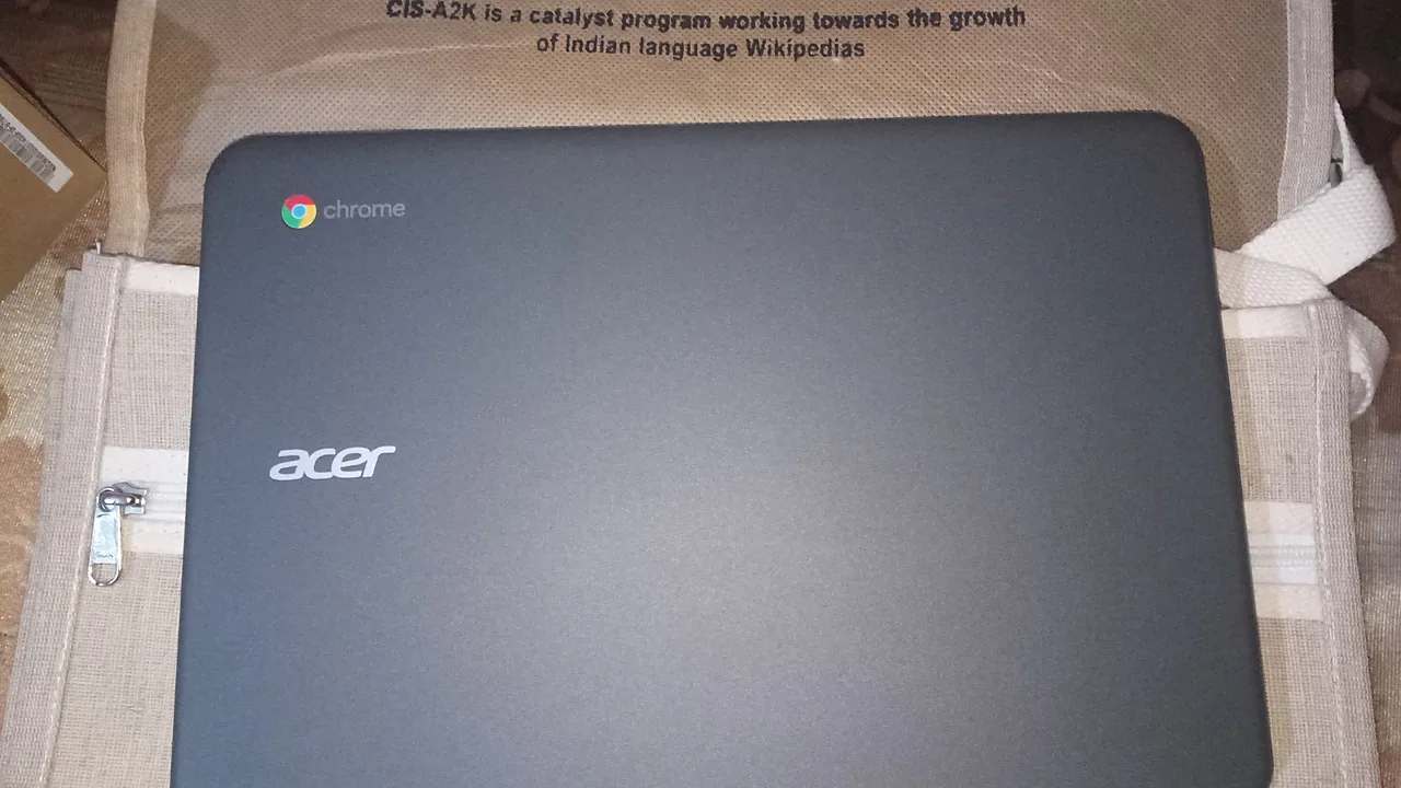 Closed Acer Chromebook showing the Chrome logo, seen from above