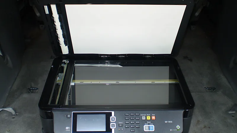 Epson WorkForce WF-7610 with the scanner lid open, showing the flatbed glass and the control panel with scan buttons