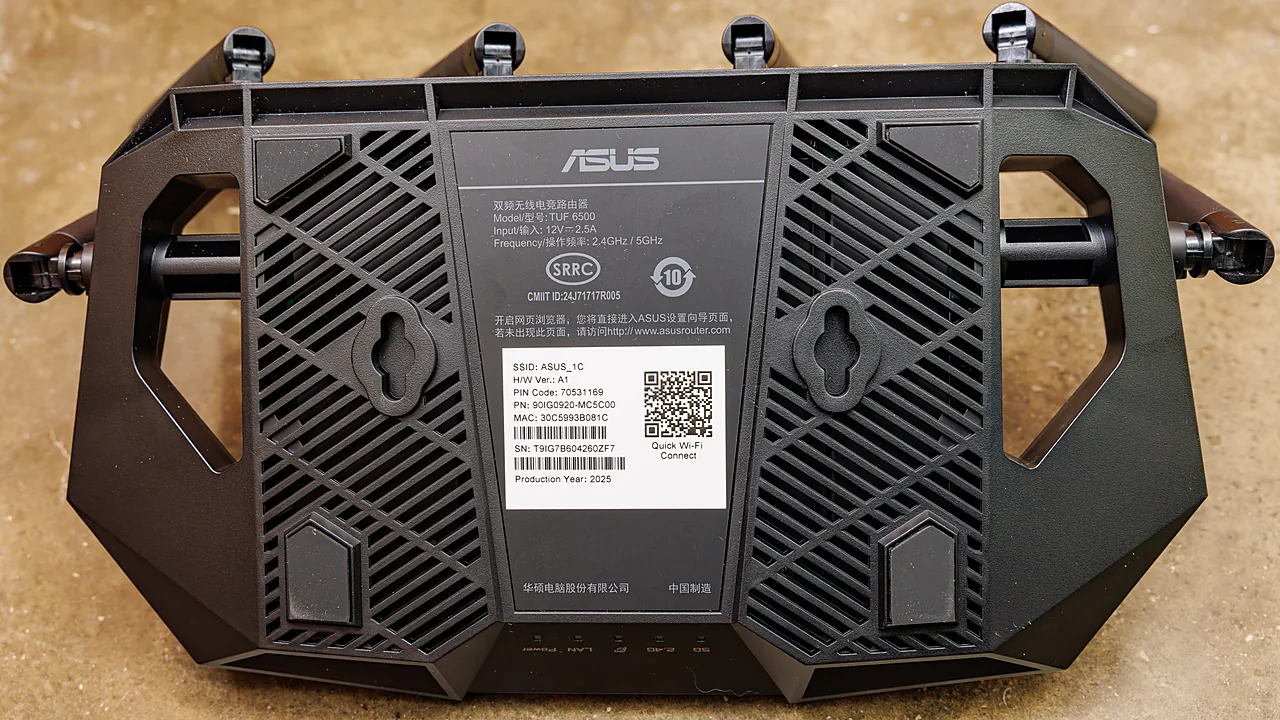Underside of an ASUS TUF Wi-Fi router showing its network label with SSID and PIN