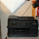 A black Lexmark OfficeEdge Pro4000 multifunction printer on a workshop bench