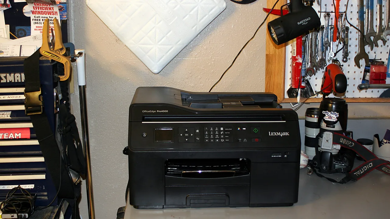 A black Lexmark OfficeEdge Pro4000 multifunction printer on a workshop bench