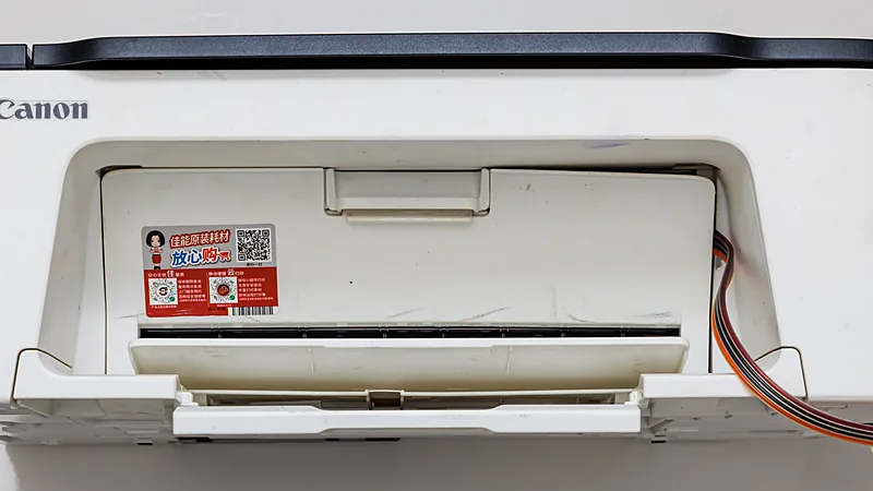 A white Canon inkjet printer with its cartridge cover open