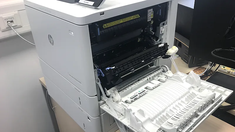 HP LaserJet Enterprise printer with its side panel open for maintenance
