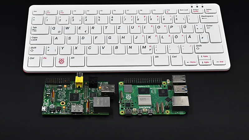 Raspberry Pi keyboard with two Raspberry Pi boards on a dark surface