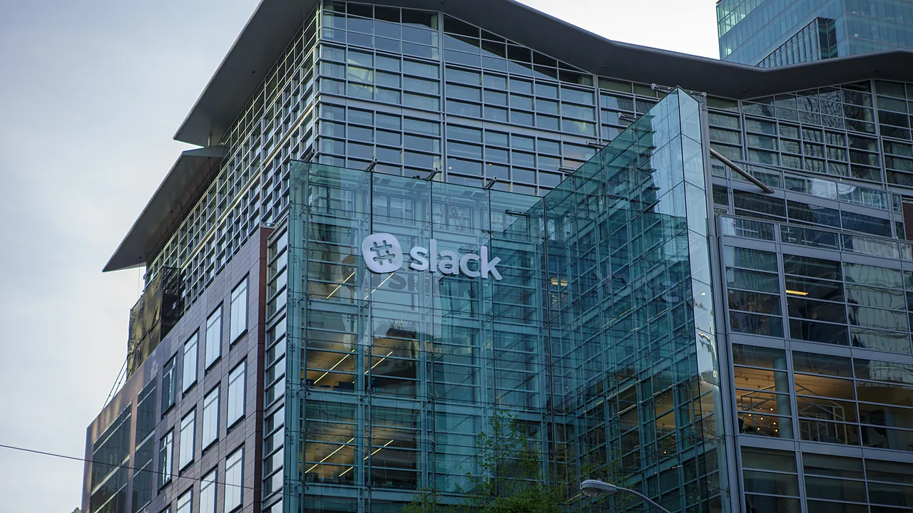 Glass office building with the Slack logo - Slack headquarters in San Francisco