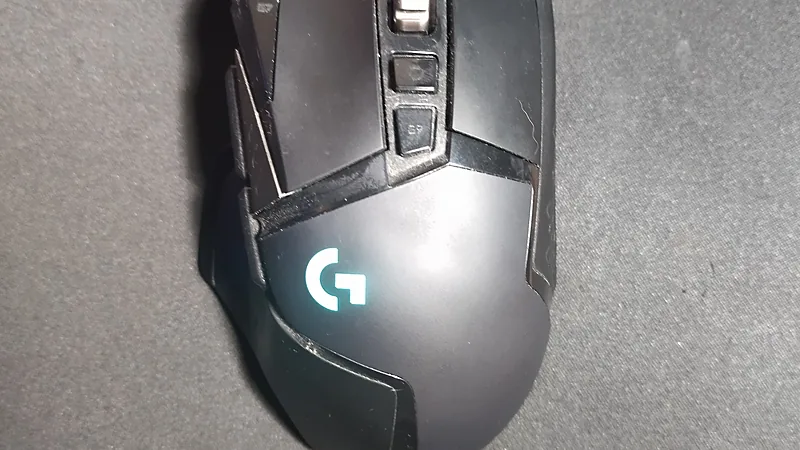 Top view of a Logitech G502 gaming mouse with lit G logo
