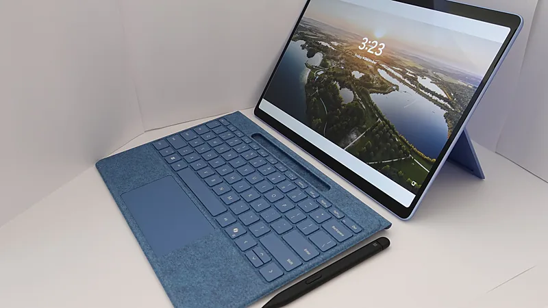 Blue Surface tablet with detached keyboard and pen at the Windows 11 lock screen