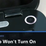 Close-up of the round power button on a black Toshiba laptop, beside the hinge and the speaker grille, with the title Laptop Won't Turn On across the lower part of the image.
