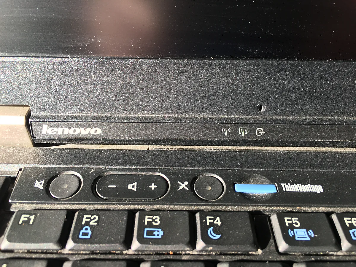 Close-up of the function key row on a Lenovo ThinkPad laptop, showing F1 to F6 with their symbol legends and the volume buttons above.