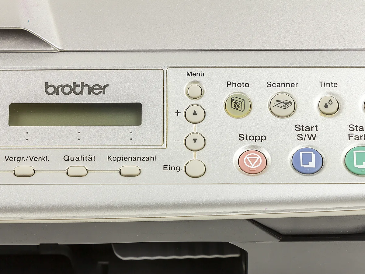 Close-up of the control panel on a Brother DCP-115C all-in-one printer, showing the Scanner button with its scanner icon beside the Photo and ink buttons.