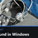 Headphones resting on a grey surface, with the title No Sound in Windows across the lower band.