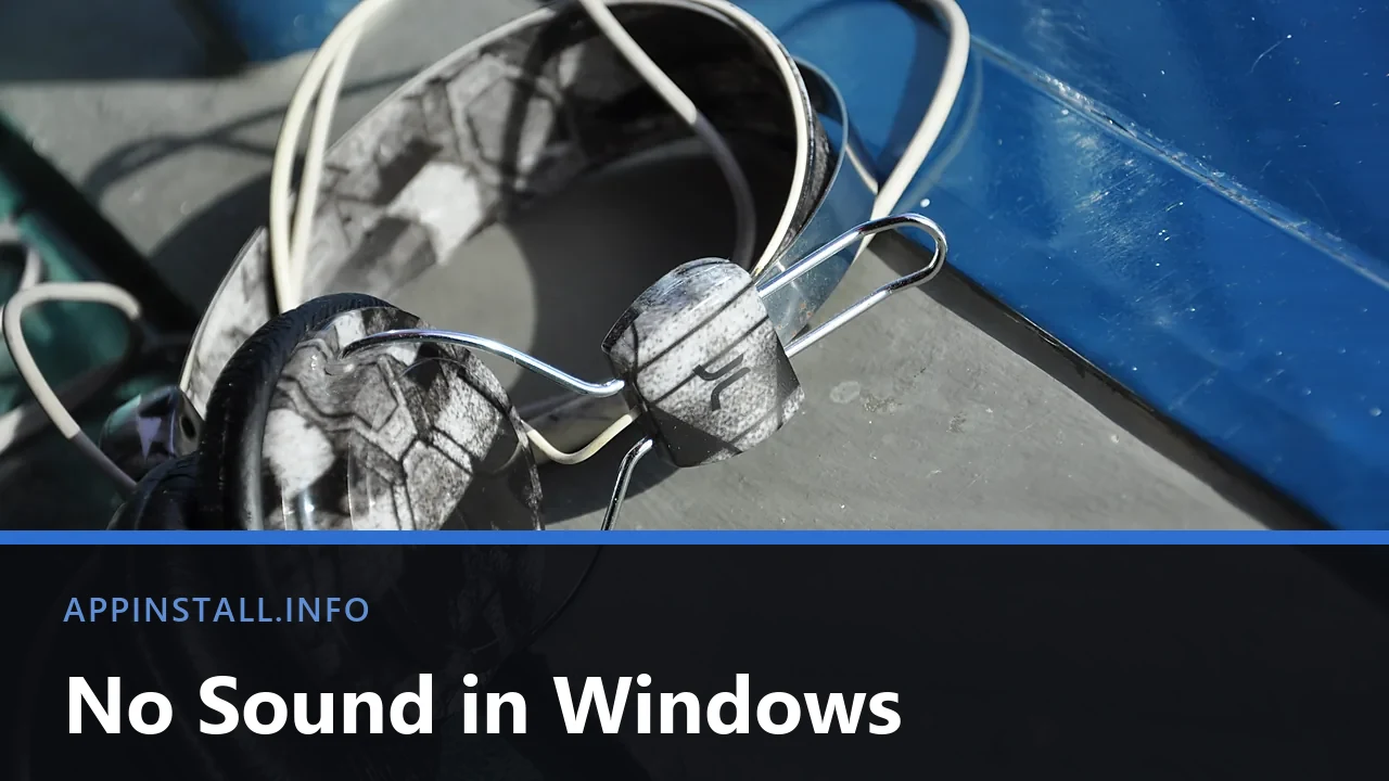 Headphones resting on a grey surface, with the title No Sound in Windows across the lower band.