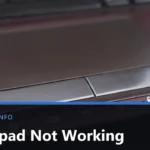 Close-up of a laptop touchpad and its two physical buttons, with the keyboard edge above, and the title Touchpad Not Working across the lower part of the image.