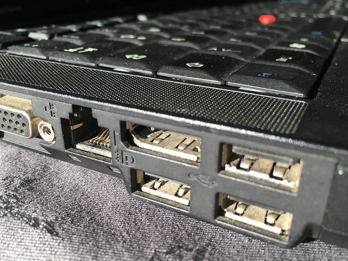 Left side of a Lenovo ThinkPad laptop showing VGA, Ethernet, DisplayPort and several USB-A ports.