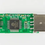 An 8 GB USB flash drive with its casing removed, exposing the controller chip and USB-A plug