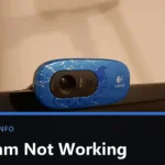 A blue Logitech webcam clipped to the top edge of a monitor, lens and microphone grille visible, with the title Webcam Not Working across the lower part of the image.